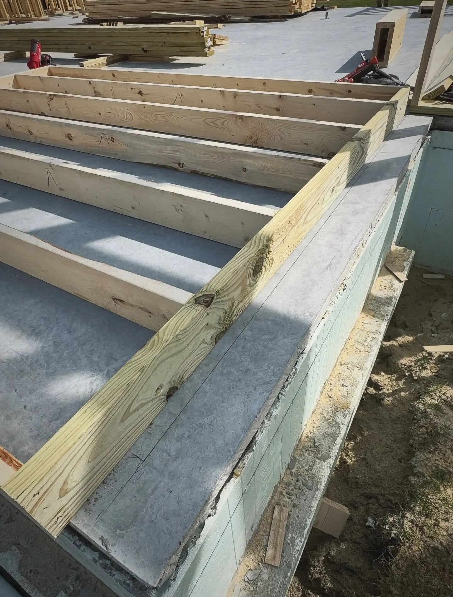 Engineered floor joist system set on an insulated foundation wall